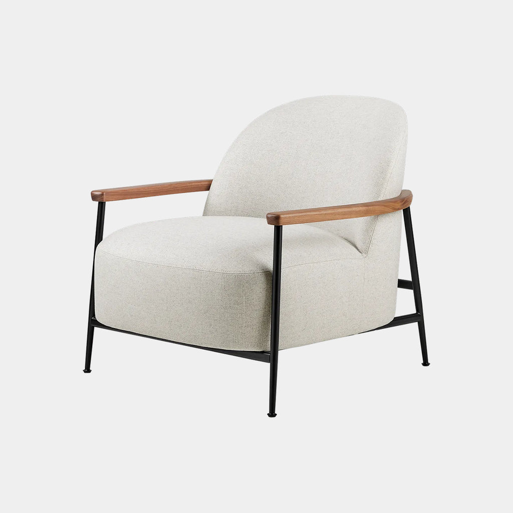 GUBI Séjour Lounge Chair upholstered in Harp fabric with rounded silhouette on a neutral background