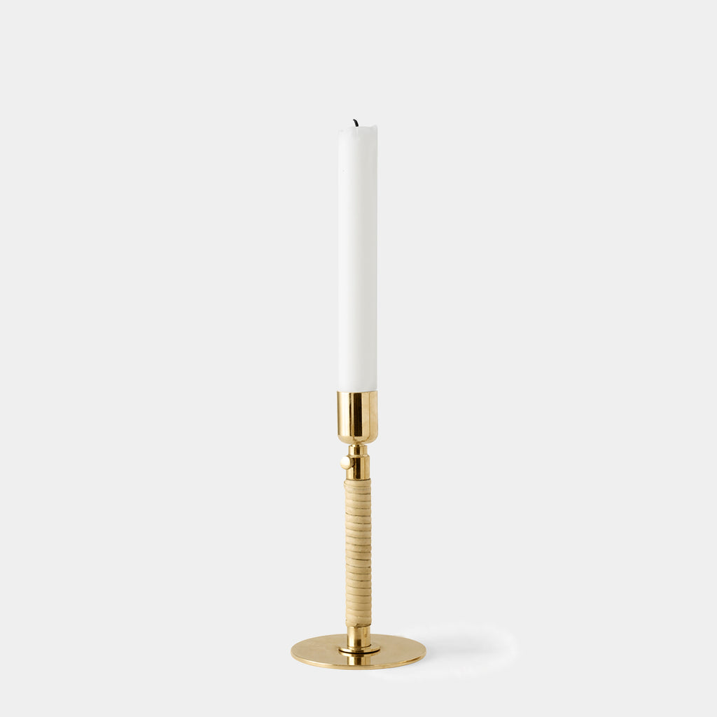 Duca Candle Holder by Audo Copenhagen in polished brass with rattan detail on neutral background