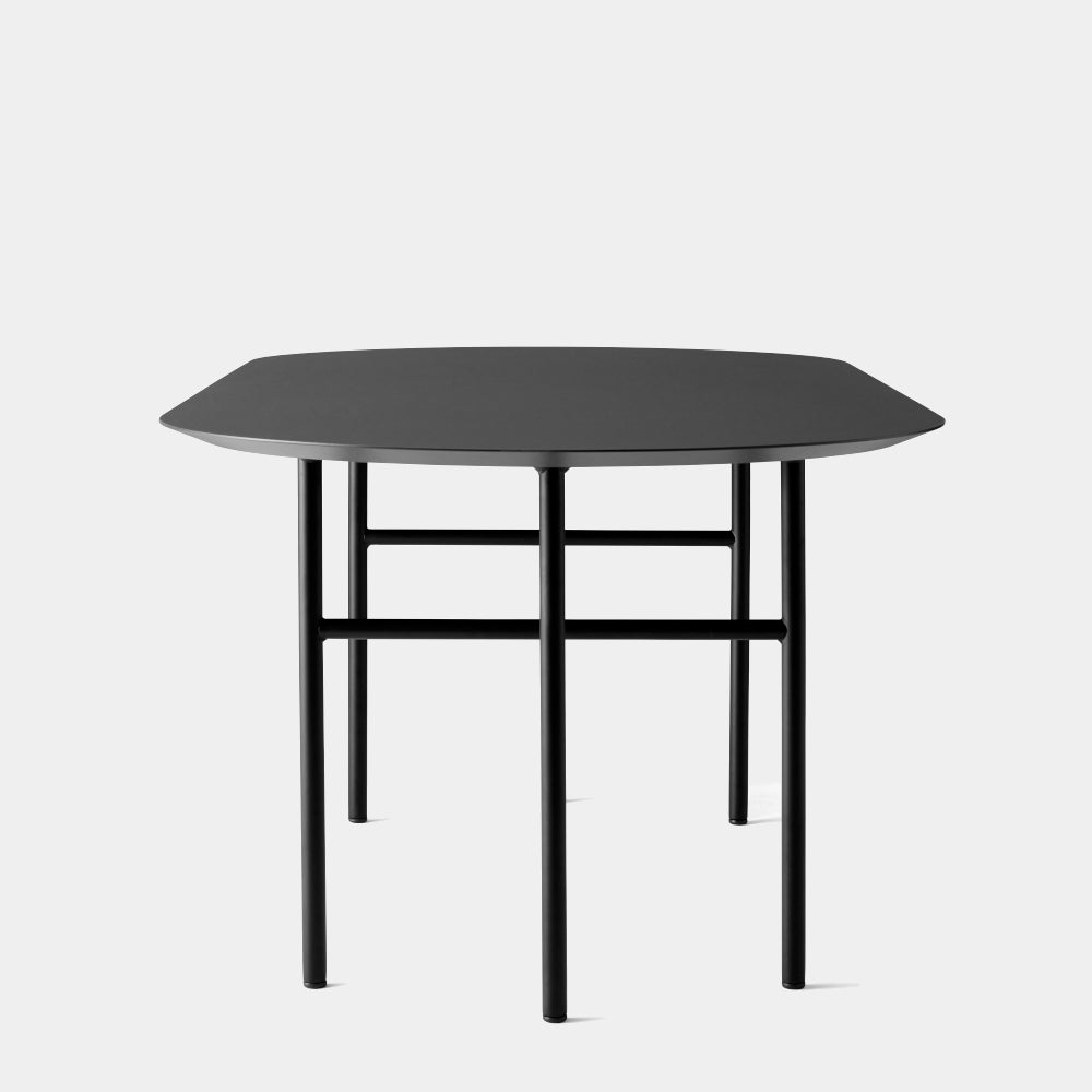 Side view of Audo Copenhagen Snaregade Oval Dining Table in Black Oak Veneer — minimalist Scandinavian dining table by Norm Architects