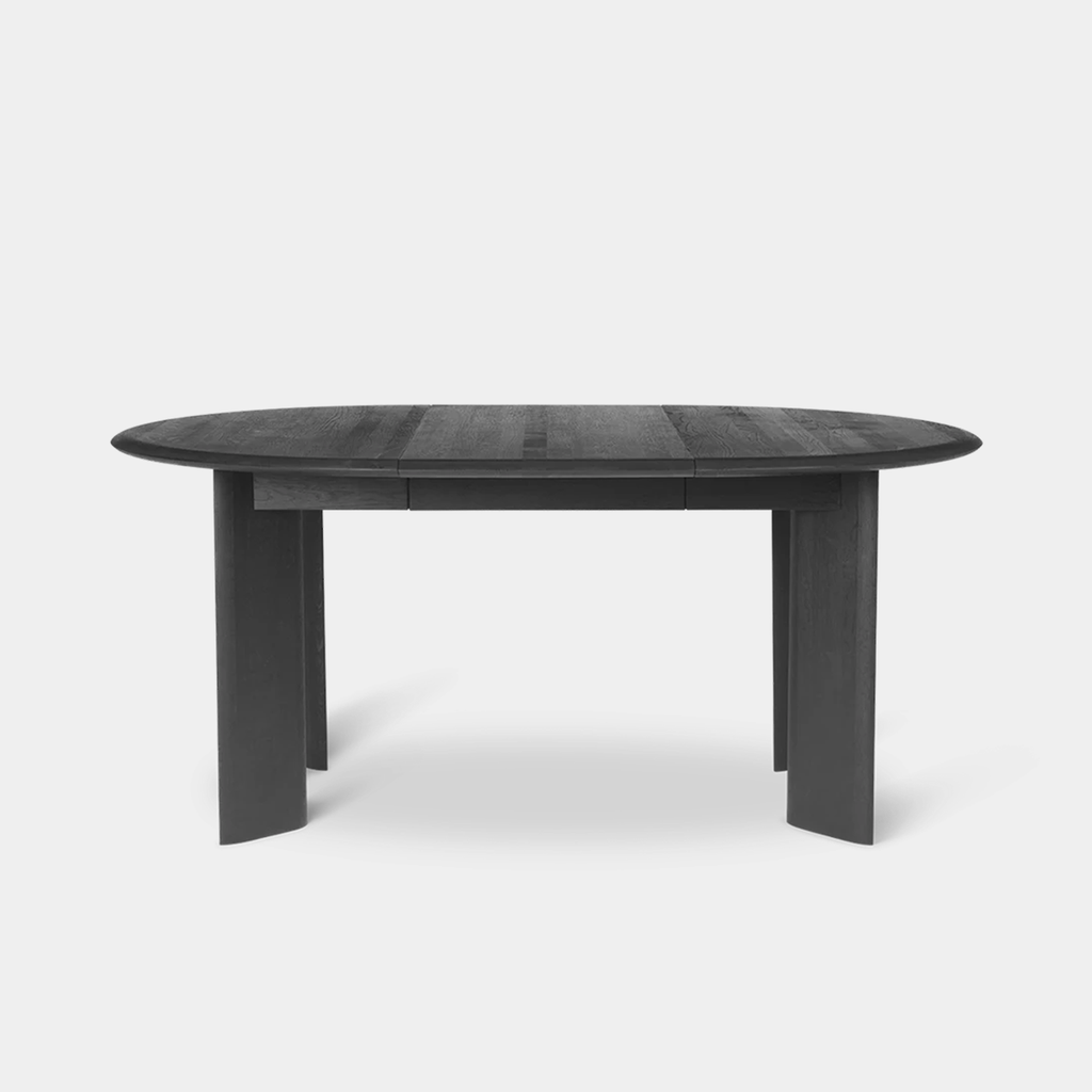 Bevel Extendable Table in black-oiled beech with matte finish, shown in oval configuration