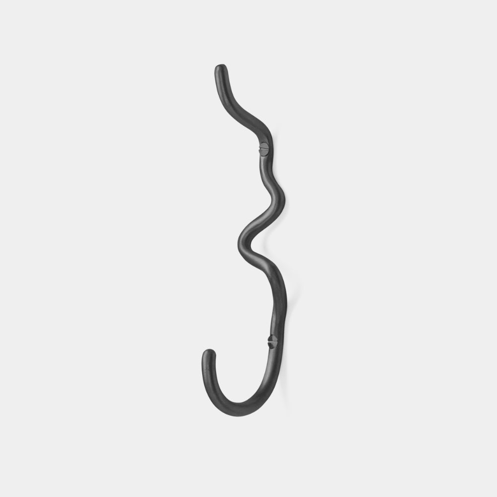 Ferm Living Curvature Hook in Brass — hand-formed solid brass wall hook with organic curved design.