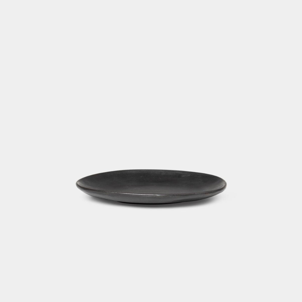 Ferm Living Flow Plate in Black size small — semi-matte glazed porcelain plate with smooth curved edges.