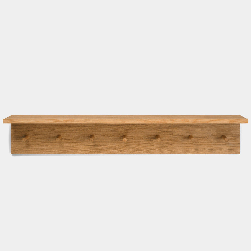 Ferm Living Place Rack in oak showing slim shelf and seven rounded hooks.