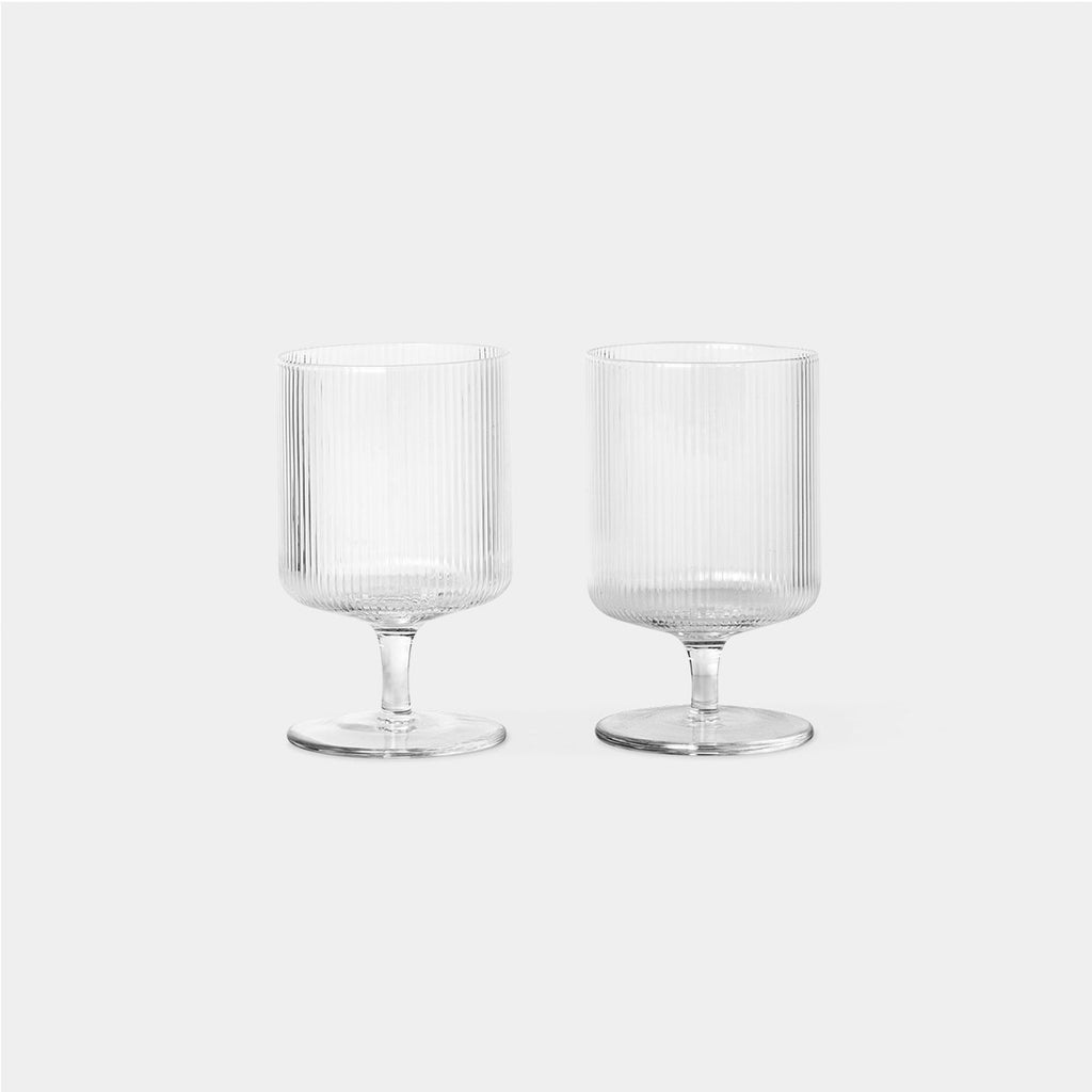 Ferm Living Ripple Wine Glasses, Set of 2 in Clear — mouth-blown ribbed glassware with sculptural silhouette.