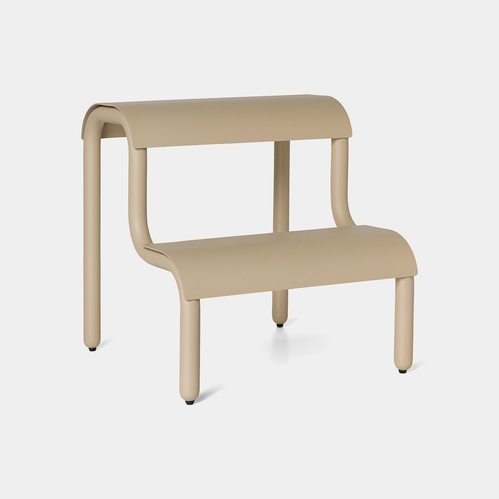 Ferm Living Up Step Stool in Cashmere—powder-coated steel, sculptural silhouette, two textured non-slip steps.